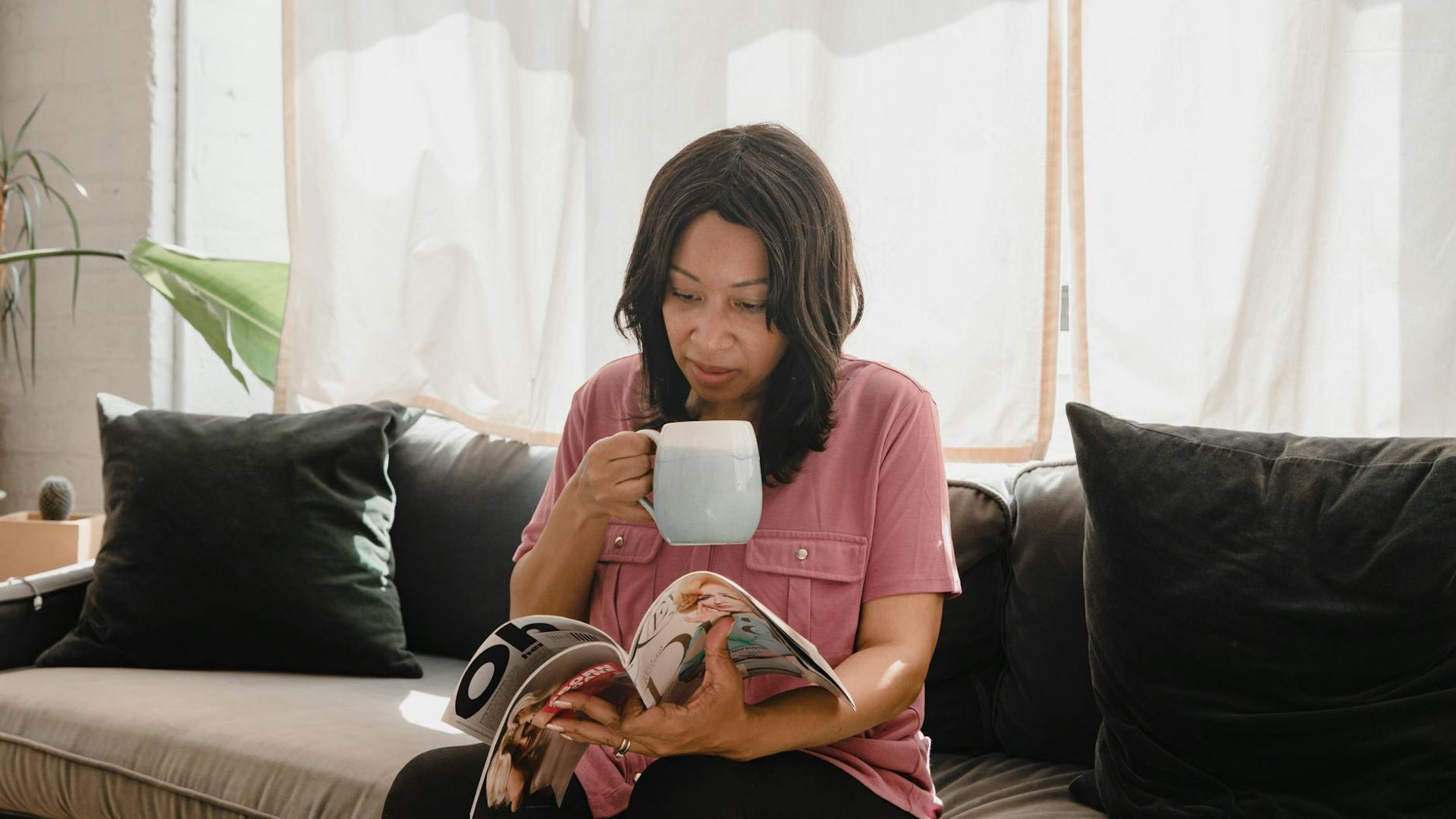 Person doing rhythmic movements in a sunlit room with minimal furniture